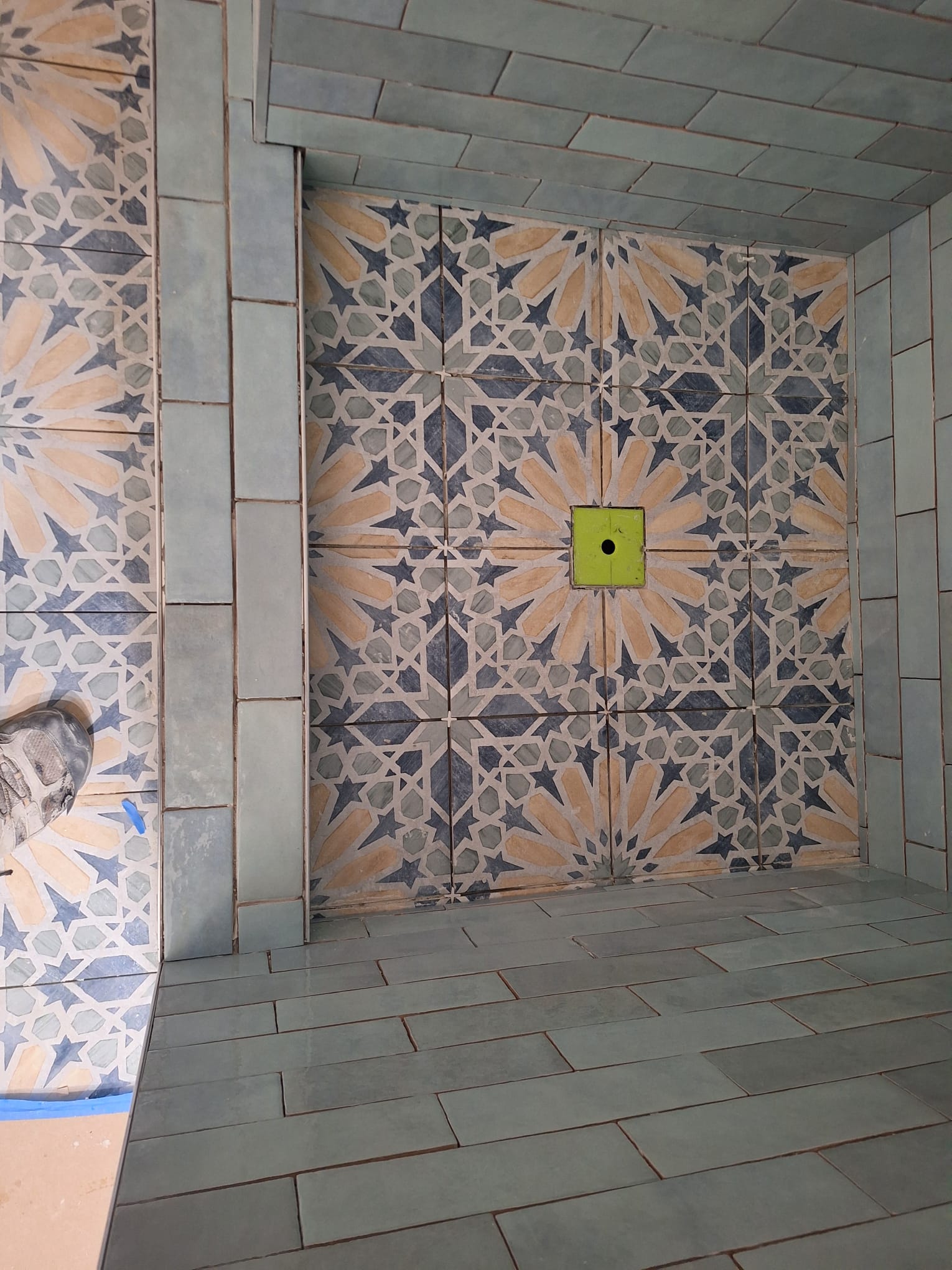 Shower wall in patterned cement tile installed in San Fernando Valley, California, with the star motif aligned across every joint